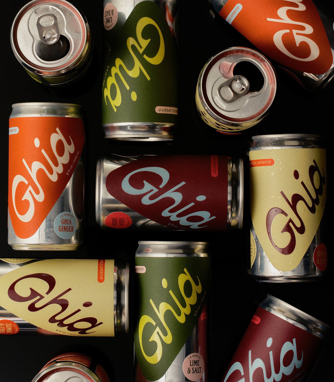 Flat lay of assorted Ghia Le Spritz cans in a mix of flavors on a black background