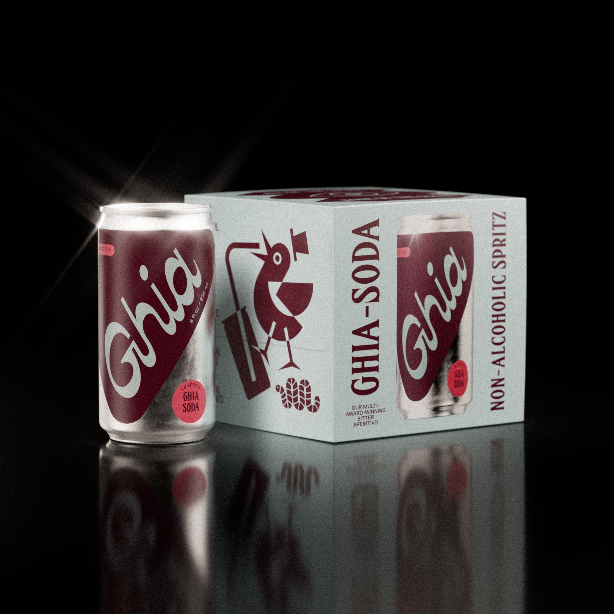 A pack of four Ghia Sumac & Chili non-alcoholic spritz cans with a burgundy box featuring illustrations. One can is placed beside the box, reflecting on a shiny surface.