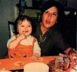 Vintage family photo of a woman and a smiling toddler at a dinner table